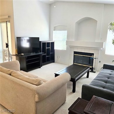 Carpeted living room with plenty of natural light