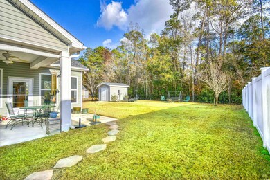 View of yard with ceiling fan and a patio area
