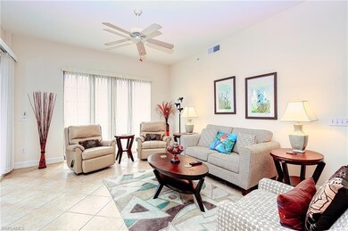 Living room featuring visible vents, ceiling fan, baseboards, and light tile patterned flooring