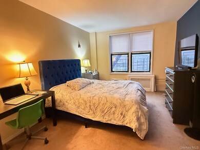 Bedroom with carpet floors and radiator