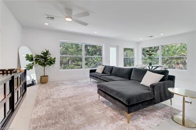 Living room with ceiling fan, visible vents, and r
