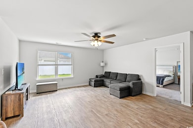 Living area with ceiling fan and wood finished floors
