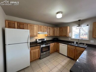 Kitchen featuring sink, light tile patterned floor