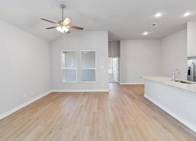 Unfurnished living room with a sink, a ceiling fa
