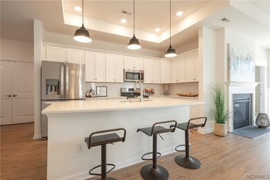 Gourmet kitchen with decorative light fixtures, tr