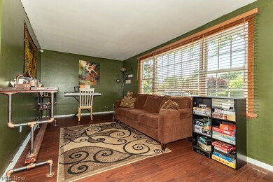 Living room with a healthy amount of sunlight and hardwood / wood-style floors