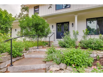Doorway to property with covered porch and brick siding