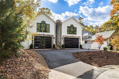 View of front of property with a garage and aphalt driveway
