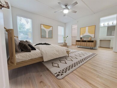 Bedroom with multiple windows, hardwood / wood-sty