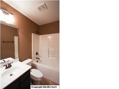 Bathroom with tile floors and cultured marble vanity tops.