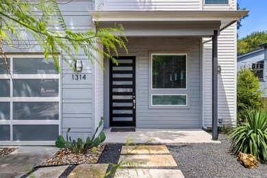 Doorway to property featuring covered porch