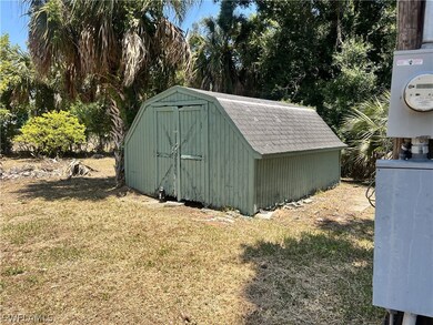 View of outdoor structure with a lawn