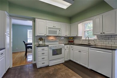 Window over sink overlooks beautiful backyard!