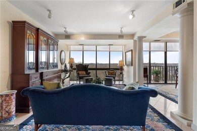 Living area featuring floor to ceiling windows, li
