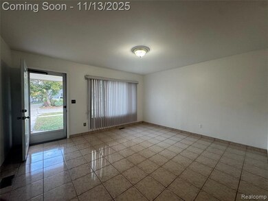 Spare room featuring light tile patterned flooring and baseboards