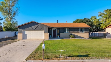 Ranch-style house featuring brick siding, concrete driveway, and a garage