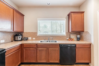 This kitchen features a sleek stainless steel doub