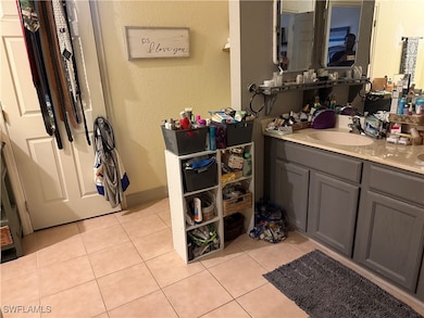 Bathroom with vanity, tile patterned floors, and a