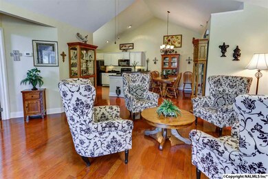 as the Living Room opens to the Dining Room and kitchen! This lovely home can seat plenty of guests and the flow of conversation is smooth!  Boasting those STUNNING hardwoods and vaulted ceiling, the Living Room is SPECTACULAR!