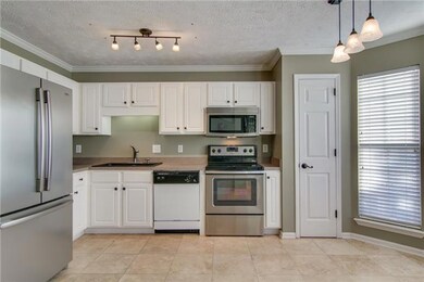 Classic white cabinets, stainless appliances, and a spacious pantry in this eat-in kitchen.