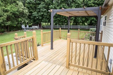 Two tiered deck on back of home with Pergola for y