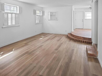 Spare room with baseboards, wood finished floors, 