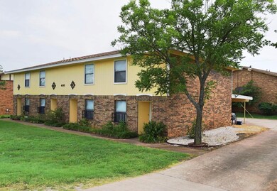 View of front of property featuring a front yard and brick siding