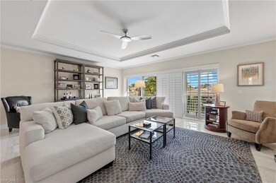 Living room featuring ceiling fan, ornamental mold