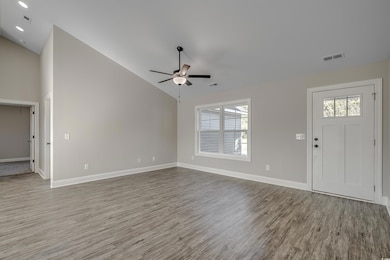Entryway featuring high vaulted ceiling, ceiling f