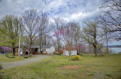 View of yard featuring a storage unit, driveway, a