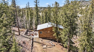 View of side of home featuring a wooded view