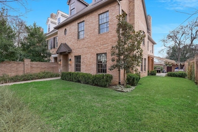 View of side of property with a yard, fence, and brick siding