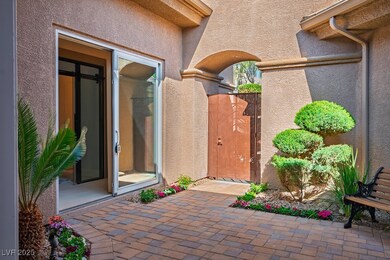 Doorway to property with stucco siding, a gate, an