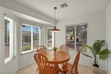 Dining space with visible vents, baseboards, and l
