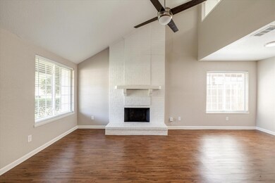 Gorgeous, floor-to-ceiling, wood burning fireplace offers a bit of warmth and ambiance for the chilly, North Texas winters. Raised hearth is the perfect spot for a basket of throws to snuggle with or magazines to unwind your frazzled mind.