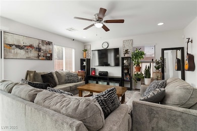 Living area with a ceiling fan and recessed lighti