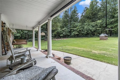 Inviting front porch, garden area & well.