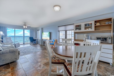 Dining room featuring stone tile floors and ceiling fan