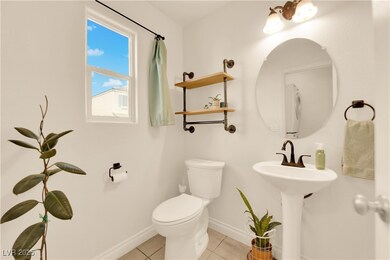Half bathroom with tile patterned flooring, a sink