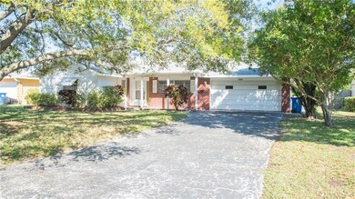 Large driveway, 2 car garage, and mature oak trees.