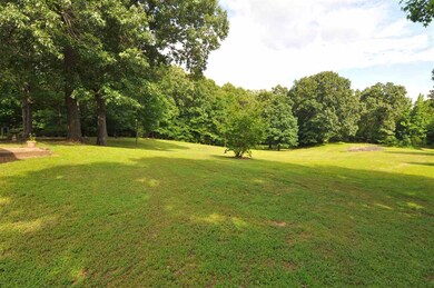 The backyard is highlighted with towering shade tr