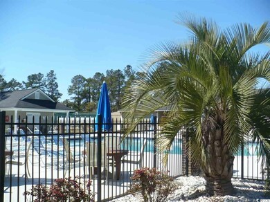Snow covered pool with fence, a community pool, and a patio