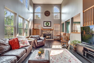 Dramatic volume ceilings and lovely fireplace in t