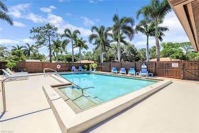 Community pool featuring a patio and fence