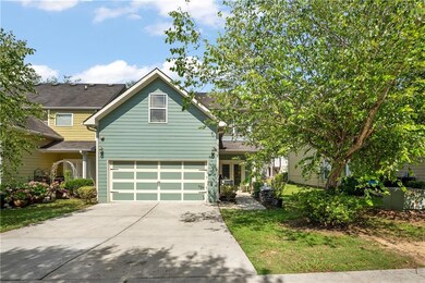 View of front of house with concrete driveway and an attached garage