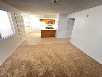 Unfurnished living room featuring light carpet, a