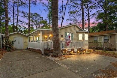 View of front of property featuring a shed, an out