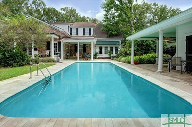 Salt water pool surrounded by four porches and gar