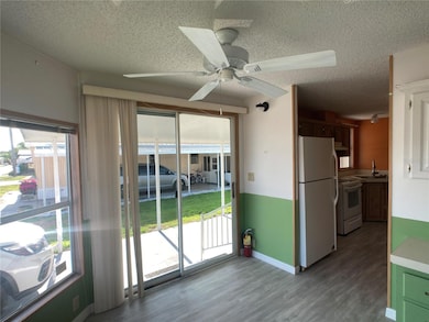 Front room-- to use as a breakfast room or office-with slider to carport- Lots of natural light!