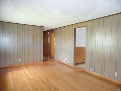 Living room has hardwood floors and seller's belie
